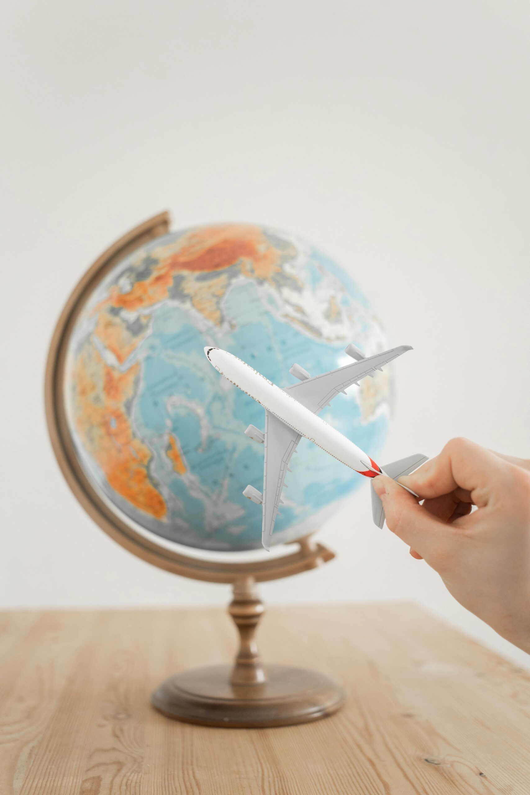 Close-Up Shot of a Person Holding an Airplane Toy